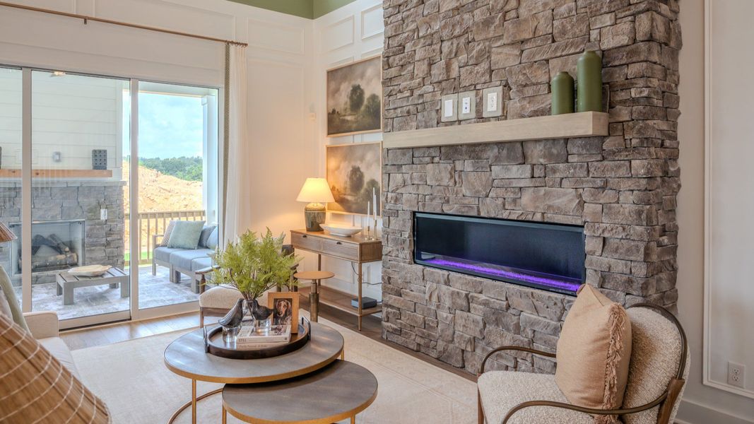 Gathering room with fireplace and access to rear patio Gathering room with fireplace and access to rear patio