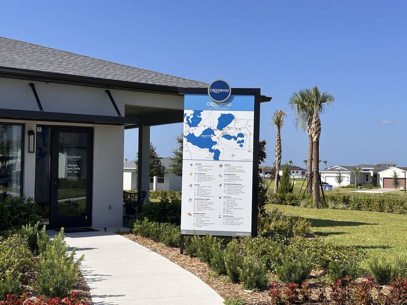 A modern home nestled in lush landscaping under a clear blue sky at Cresswind at Lake Harris by Kolter Homes (Tavares, FL).