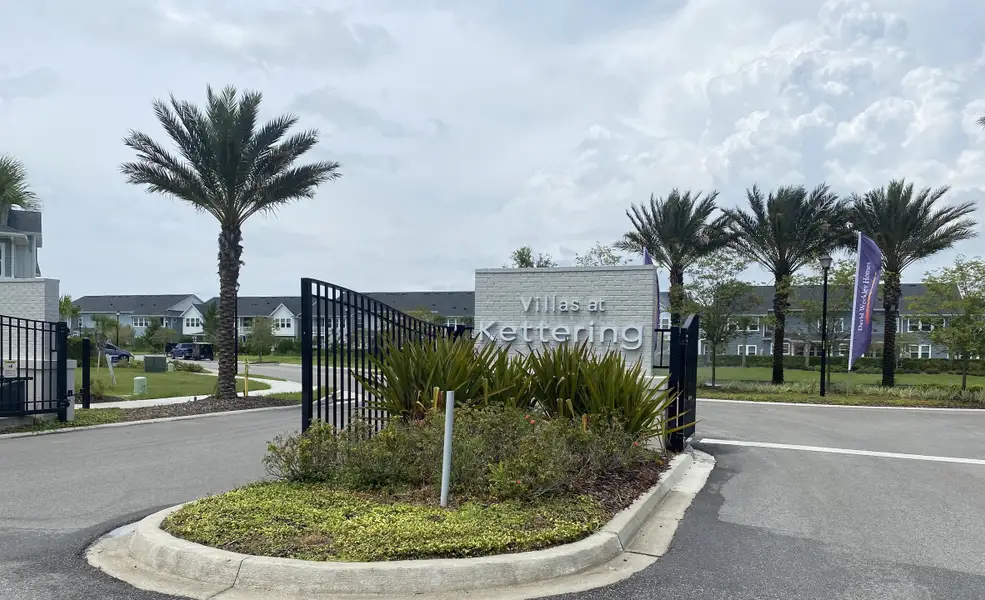 A welcoming entrance with palm trees at Kettering at eTown - Garden Collection by David Weekley Homes (Jacksonville, FL).