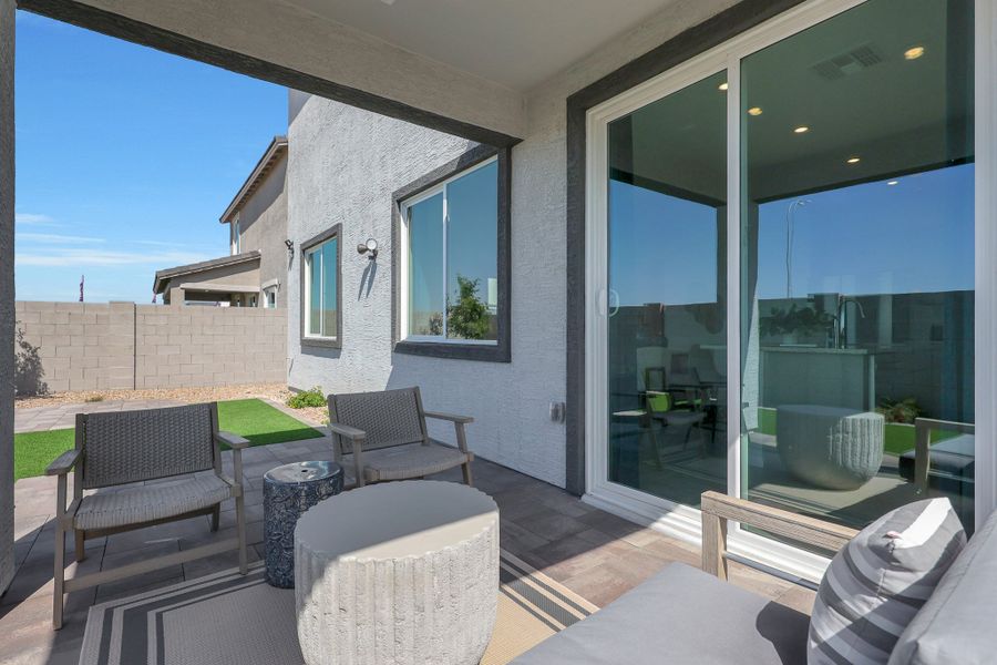 A patio with chairs and a table. A patio with chairs and a table.