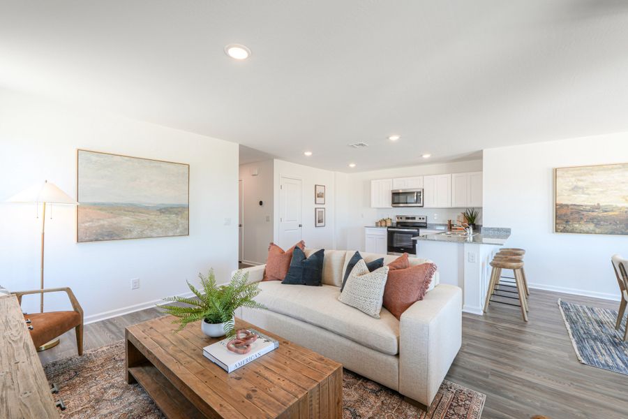 A living room with a couch and a coffee table. A living room with a couch and a coffee table.