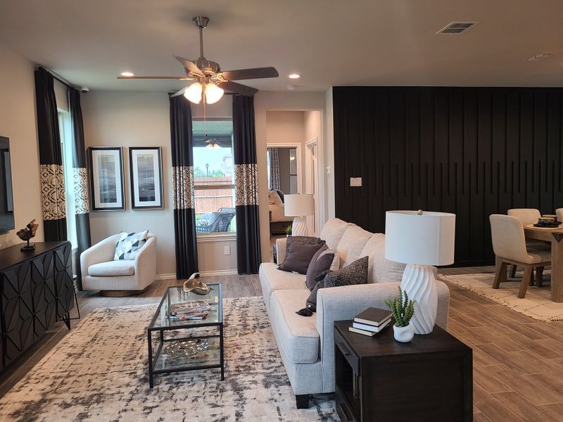 A modern living room with a cozy beige sofa, elegant décor, and contemporary lighting in a stylish open-concept space.