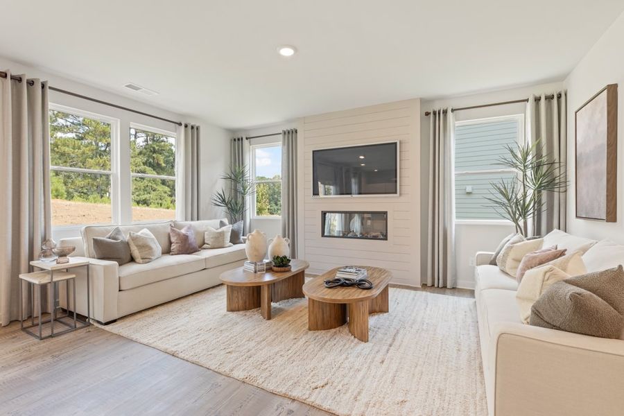 A living room with a large window. A living room with a large window.