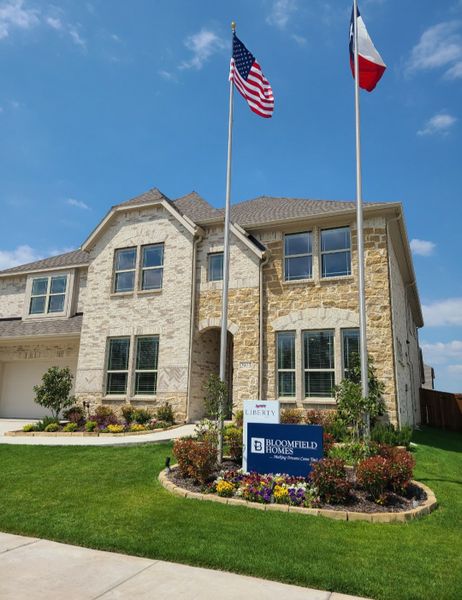 A beautiful stone home with manicured landscaping in Liberty by Bloomfield Homes (Melissa, TX). A beautiful stone home with manicured landscaping in Liberty by Bloomfield Homes (Melissa, TX).