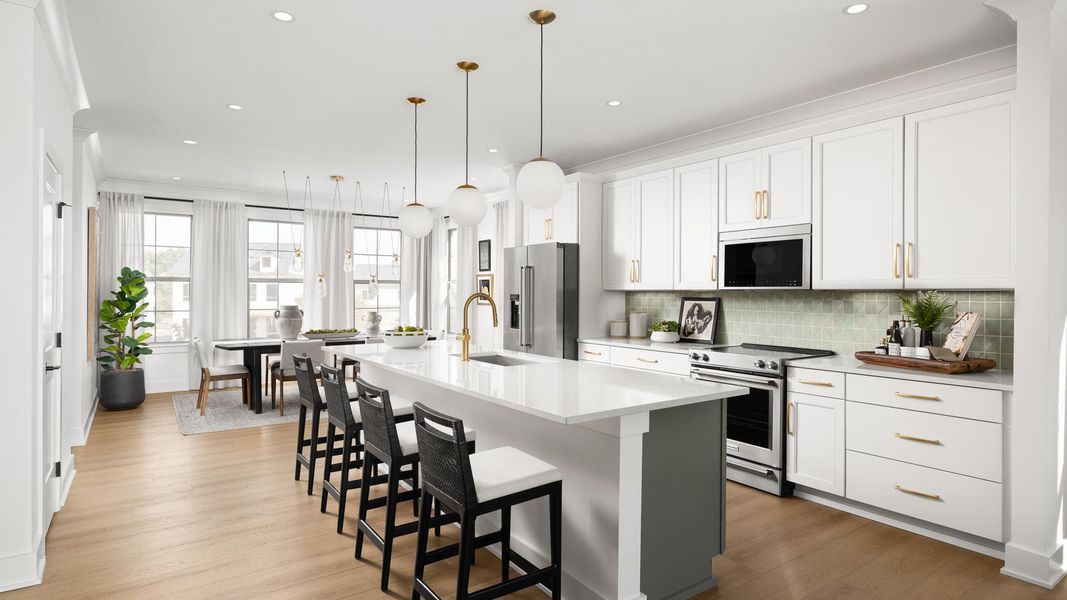 Gourmet kitchens boasts a large center island and stainless steel appliances