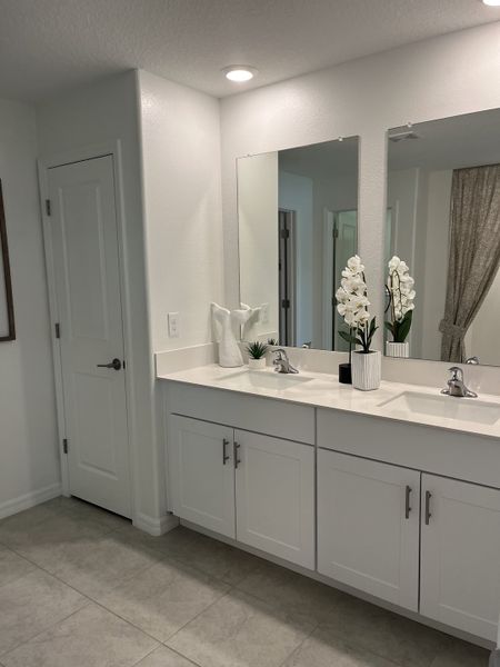 Modern bathroom with dual sinks, sleek white cabinetry, and soft lighting for a clean, elegant look. Modern bathroom with dual sinks, sleek white cabinetry, and soft lighting for a clean, elegant look.