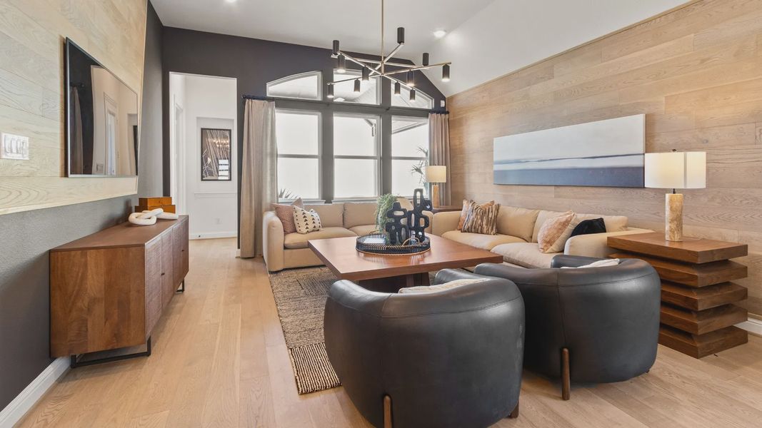 Elegant living room features wood accents and sleek lighting, offering style and comfort in River Ranch.