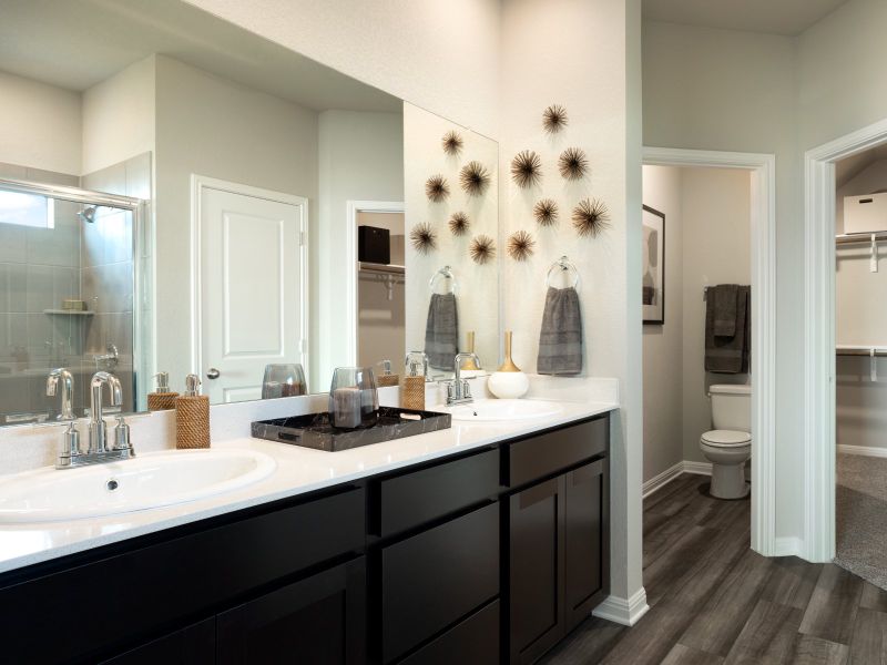 The primary bathroom has double sinks and plenty of counter space.