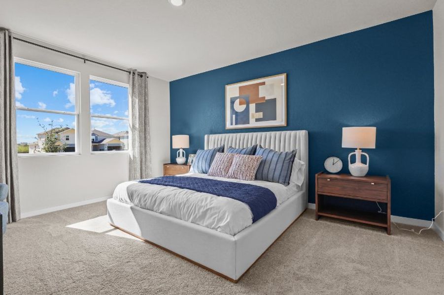 A bedroom with a bed and lamps.