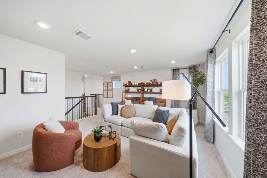 A living room with a couch and a table. A living room with a couch and a table.