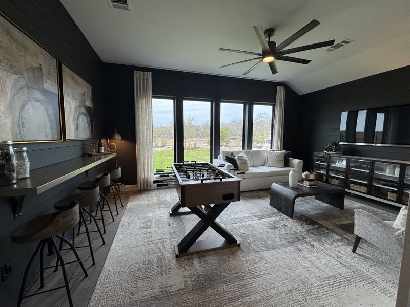 A chic game room with a foosball table, cozy seating, large windows, and modern decor. A chic game room with a foosball table, cozy seating, large windows, and modern decor.