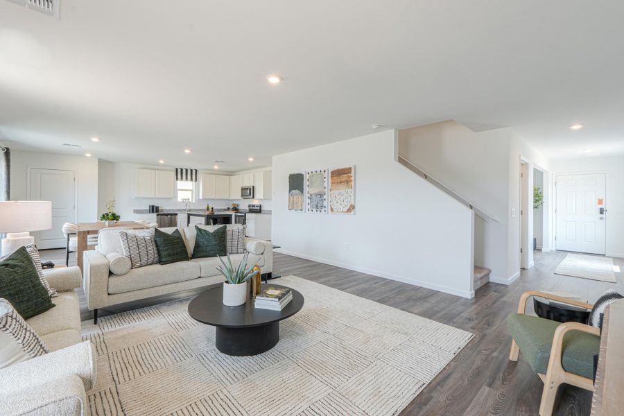 A living room with a couch and a coffee table. A living room with a couch and a coffee table.