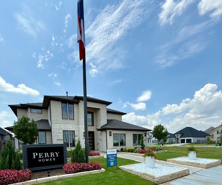 A beautiful two-story home with manicured gardens in Stonecreek Estates 60' by Perry Homes (Richmond, TX).