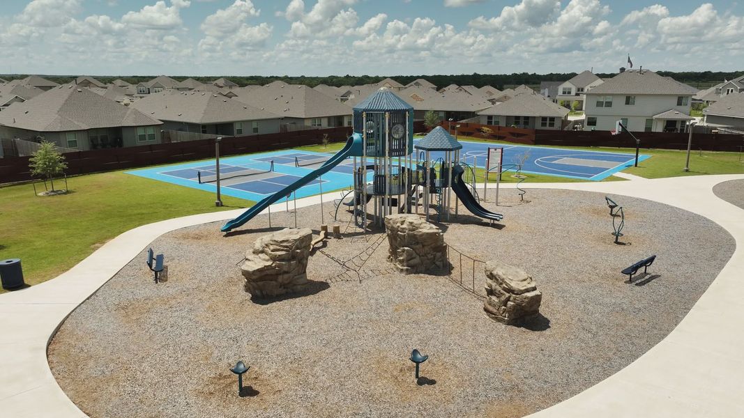 Elegant playground with sleek slides and vibrant sports court in Southern Pointe, College Station.