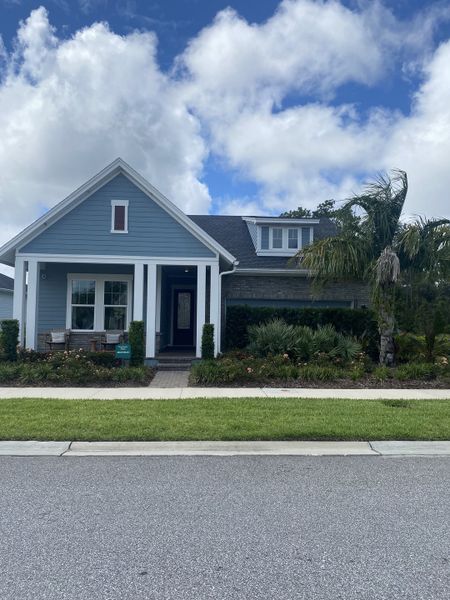 A charming blue home with lush landscaping in Seven Pines by ICI Homes, Jacksonville, FL.