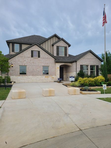 Elegant white brick home with dark shutters and lush landscaping in Kings Way by M/I Homes (Denton, TX). Elegant white brick home with dark shutters and lush landscaping in Kings Way by M/I Homes (Denton, TX).