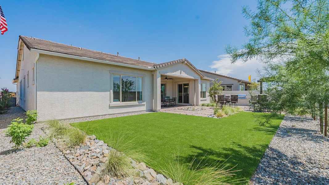 Experience elegance with lush lawns and desert-inspired landscape in this Windrose residence.