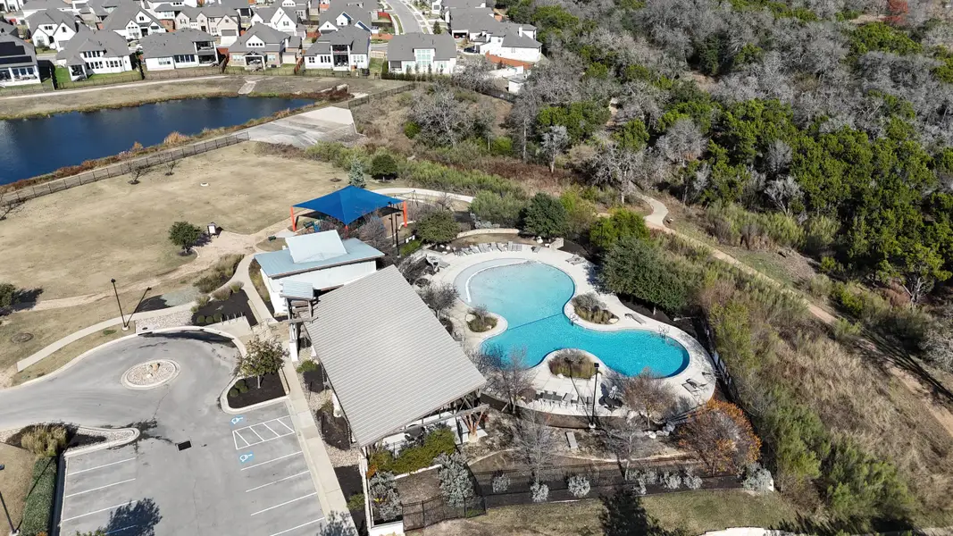 Aerial view of amenities, including a pool and clubhouse, in the Oaks at San Gabriel by Brohn Homes (Georgetown, TX).