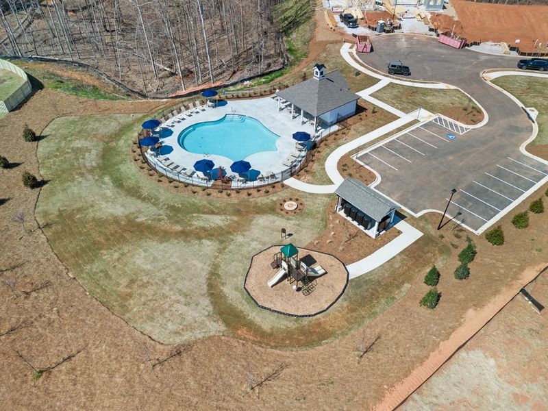 A person riding a bicycle in a courtyard with a pool. A person riding a bicycle in a courtyard with a pool.