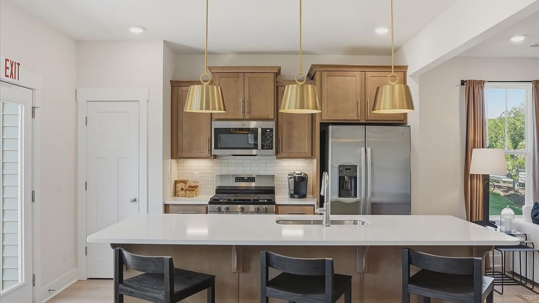 Vibrant kitchen layout with a center island, refined finishes, and open-concept flow at El Dorado