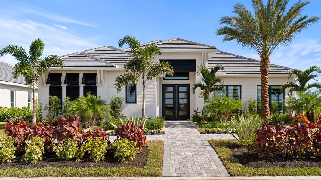 Front exterior of a home in the Glynlea Country Club 60' community, located in Port St. Lucie, FL (Image 4).