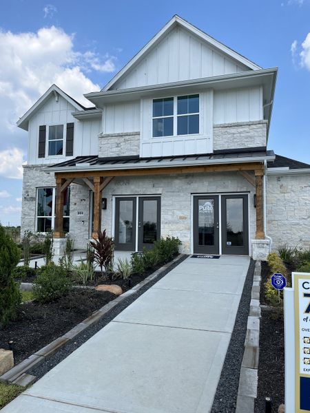 Modern white stone home with elegant landscaping in Windcress by Pulte Homes (Cove, TX).