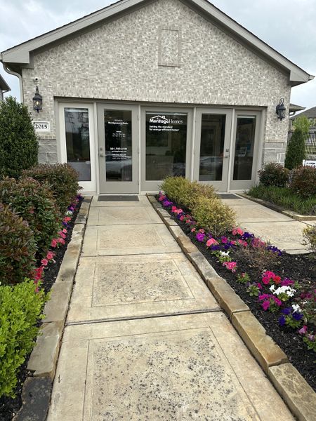 Charming entrance with flourishing flowers at Montgomery Oaks by Meritage Homes in Conroe, TX. Charming entrance with flourishing flowers at Montgomery Oaks by Meritage Homes in Conroe, TX.