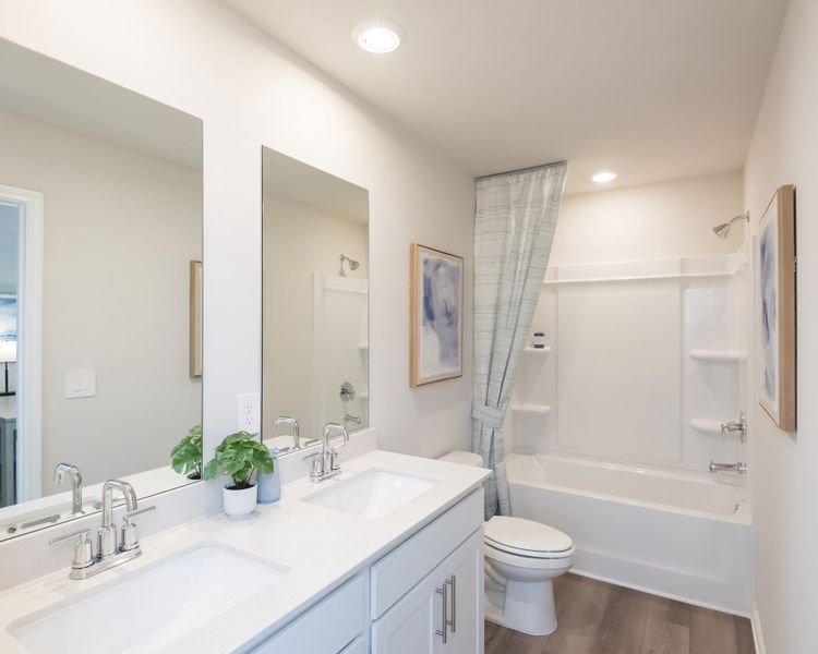 A functional and spacious secondary bath for guests or family.