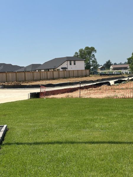 Expansive construction site under clear skies in Montgomery Ridge: Founders Collection by Beazer Homes (Montgomery, TX).