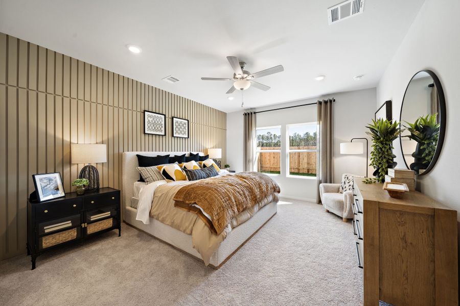 A bedroom with a large window.