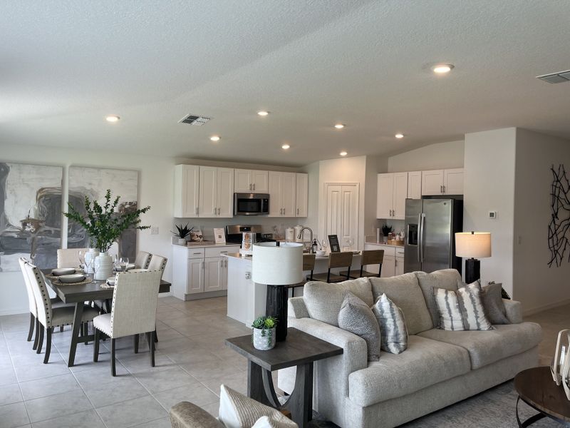 An elegant open-concept living space with a modern kitchen, dining area, and cozy seating, featuring neutral tones and stylish decor. An elegant open-concept living space with a modern kitchen, dining area, and cozy seating, featuring neutral tones and stylish decor.