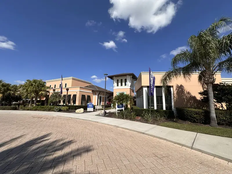 A stylish clubhouse with Mediterranean architecture and lush landscaping in Solara Resort by Mattamy Homes (Kissimmee, FL).