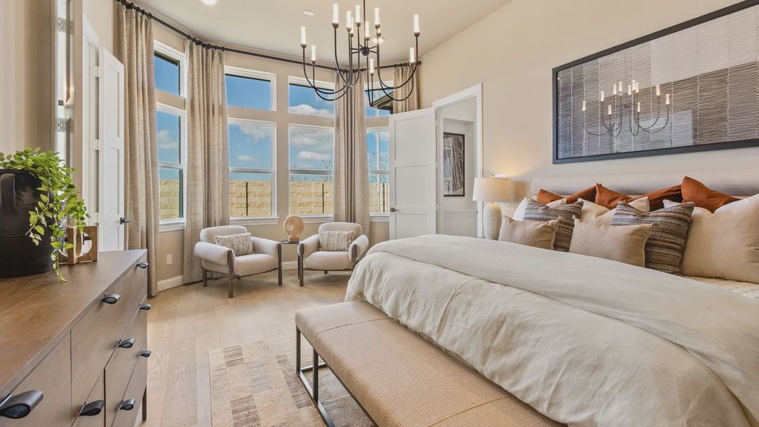 Luxurious River Ranch bedroom with a striking bay window and stylish modern chandelier.
