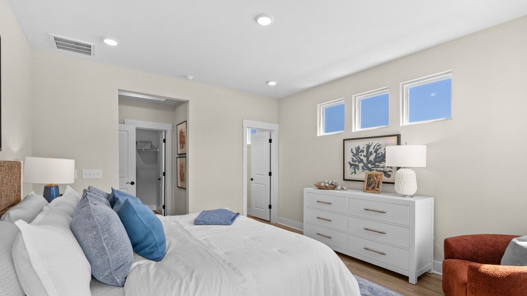 The Summit primary suite offers a spacious retreat with comfort and style.