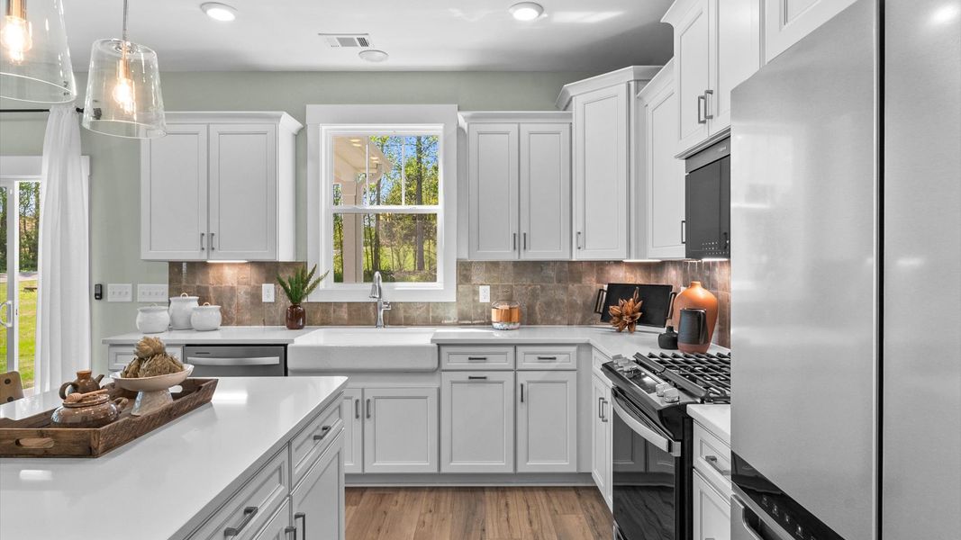 Accomplished design in a kitchen that blends function and form with a right-sized island Accomplished design in a kitchen that blends function and form with a right-sized island