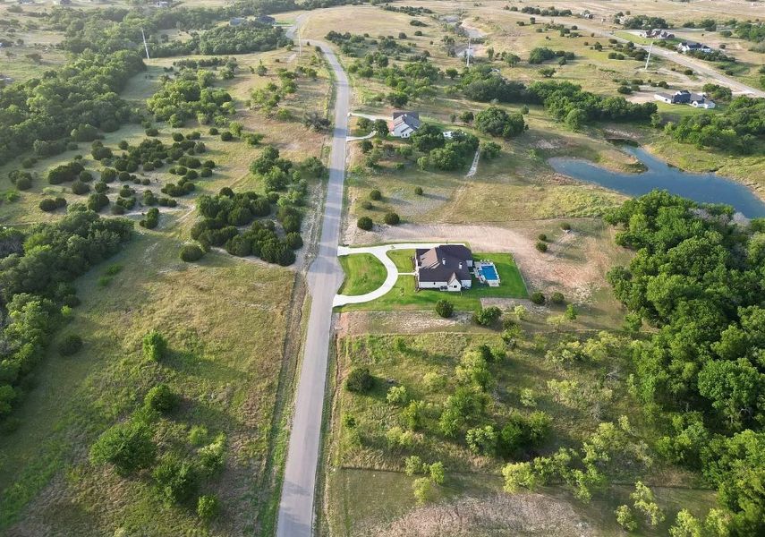 Aerial view of the Woodland Lakes community in Weatherford, TX, showing layout and nearby surroundings (Image 12). Aerial view of the Woodland Lakes community in Weatherford, TX, showing layout and nearby surroundings (Image 12).