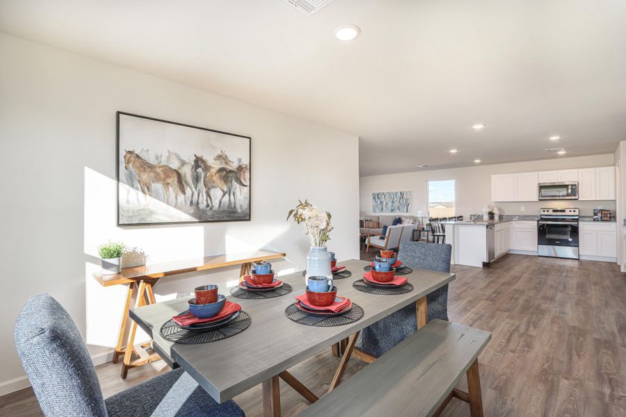 A dining room with a table and chairs. A dining room with a table and chairs.