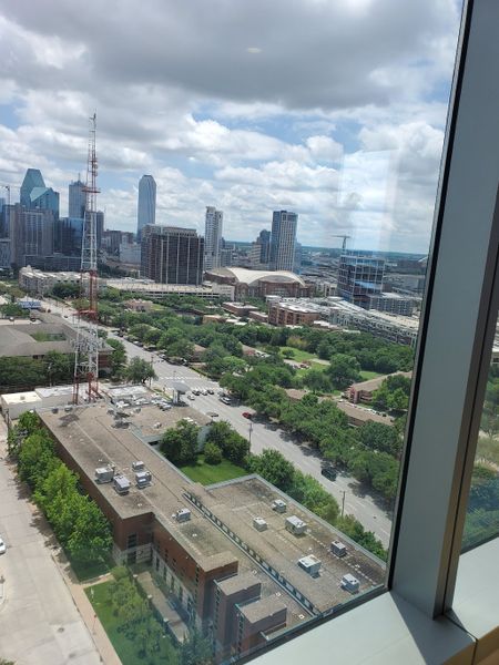 A breathtaking cityscape view from a high-rise in Bleu Ciel by Harwood International, showcasing Dallas, TX's urban panorama.