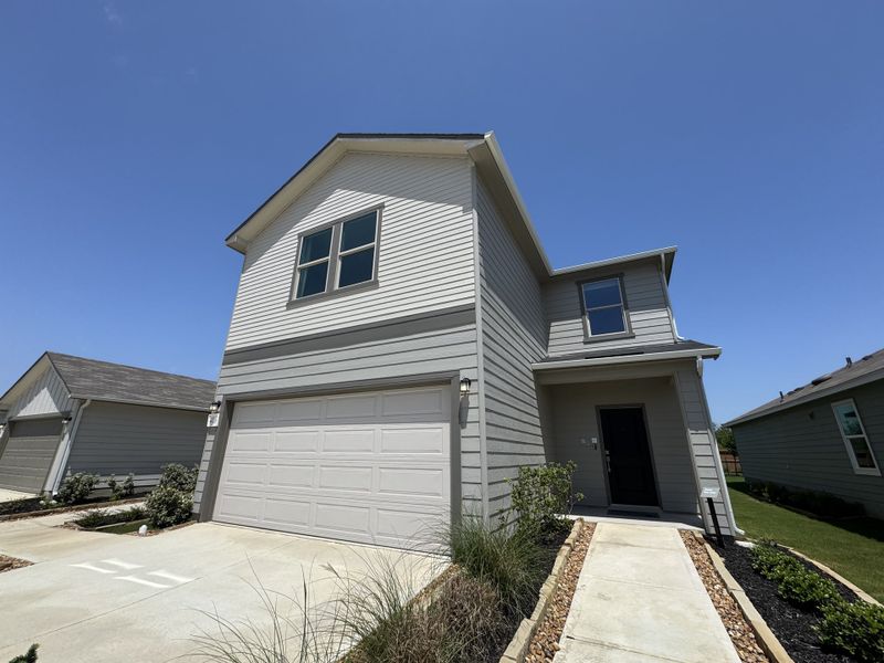 A modern gray two-story home with a welcoming front yard in Spanish Trails by KB Home (San Antonio, TX). A modern gray two-story home with a welcoming front yard in Spanish Trails by KB Home (San Antonio, TX).