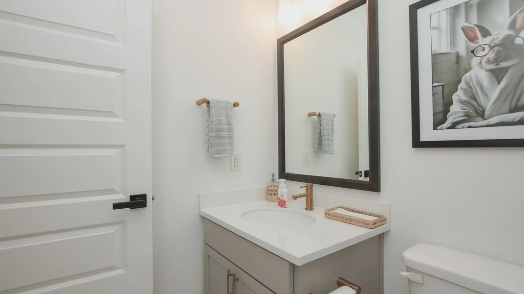 Sophisticated Ellis Cove bathroom with a quartz countertop, chic fixtures, and soothing neutral tones. Sophisticated Ellis Cove bathroom with a quartz countertop, chic fixtures, and soothing neutral tones.
