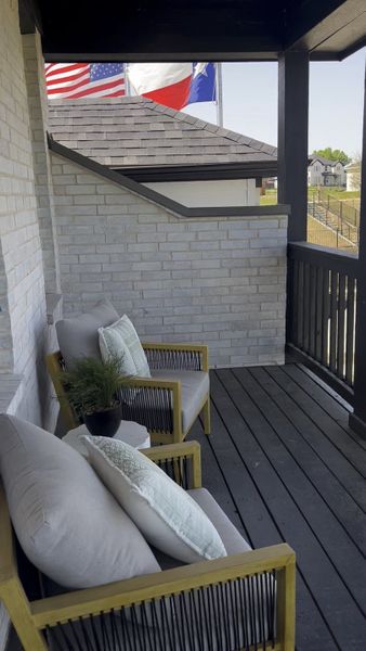 A cozy balcony with stylish seating, neutral cushions, and decorative plants. A cozy balcony with stylish seating, neutral cushions, and decorative plants.
