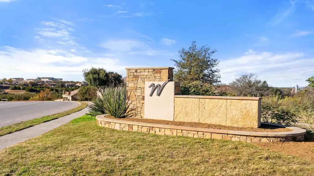 Entrance to the Sola Vista at West Cypress Hills community in Briarcliff, TX, featuring signage and landscaping (Image 2). Entrance to the Sola Vista at West Cypress Hills community in Briarcliff, TX, featuring signage and landscaping (Image 2).
