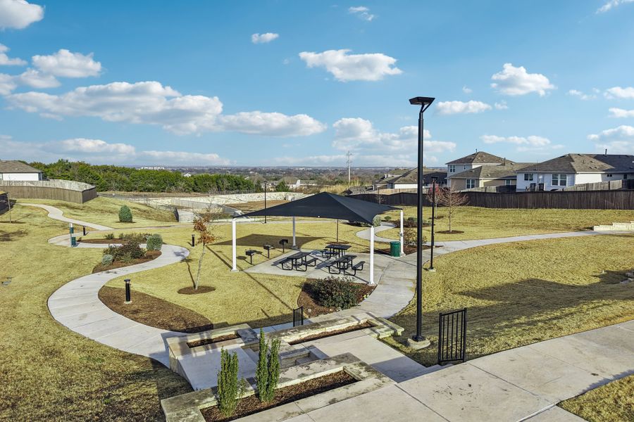 A large green lawn with a fountain.