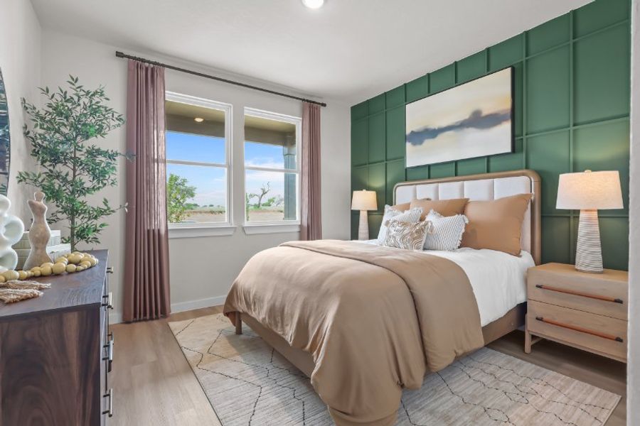 A bedroom with a large window. A bedroom with a large window.