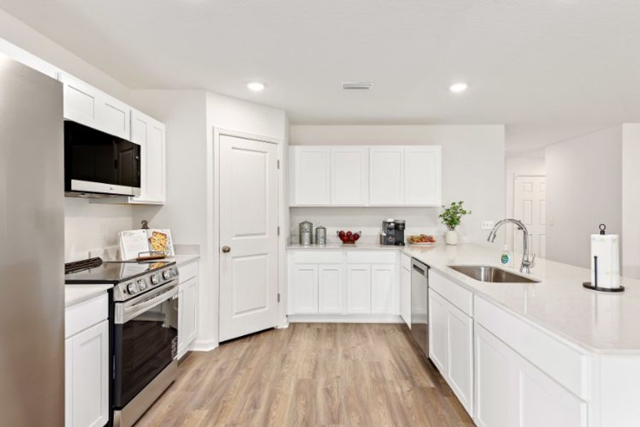 A kitchen with white cabinets. A kitchen with white cabinets.