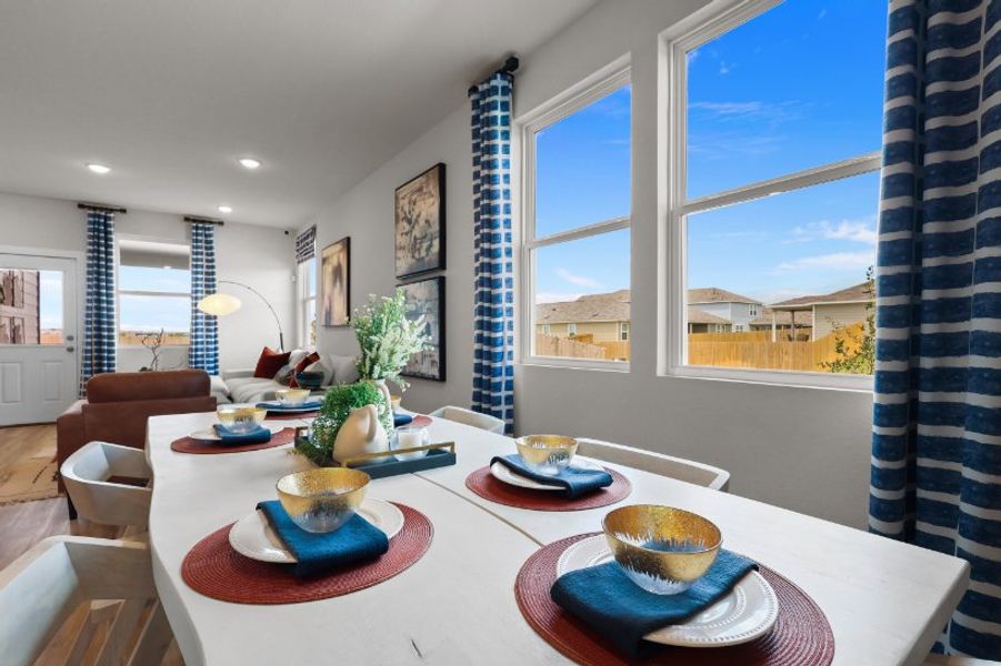 A dining room with a large window.