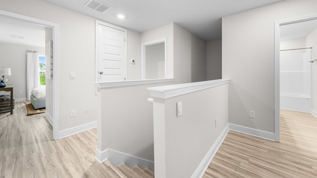 Furnished interior in a model home at WindMark Townhomes in Port Saint Joe (Image 20).