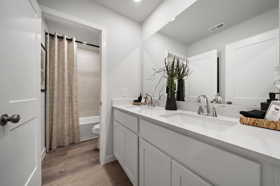 A bathroom with a tub sink and toilet.