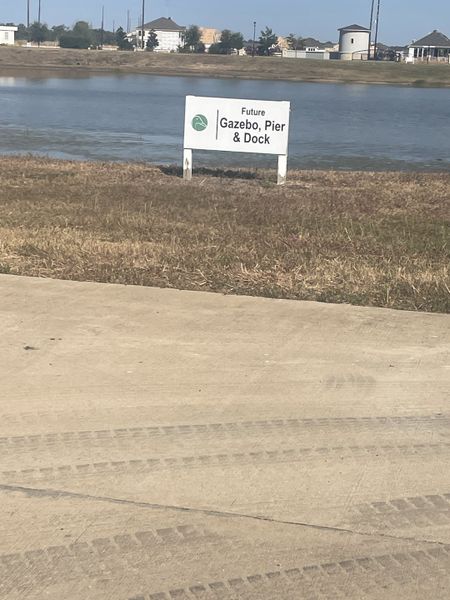 Future gazebo, pier, and dock area by a serene lake at Tealpointe Lake Estates by Jamestown Estate Homes (Tomball, TX).