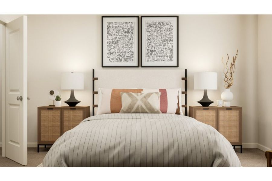 A bed with a white bed spread.